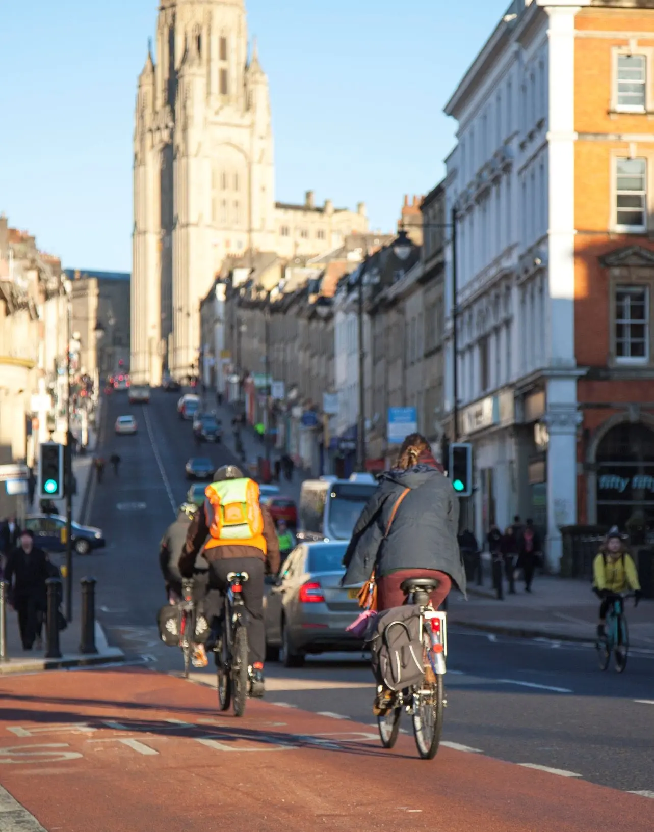 Three cyclists about to cycle up a hill